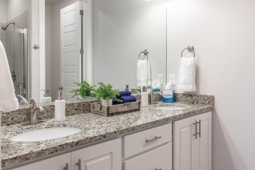a bathroom with two sinks and a mirror at Pleasant View in St. George