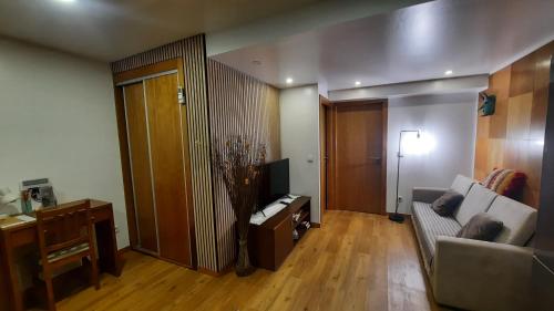 a living room with a couch and a table at Apimonte City House B in Bragança