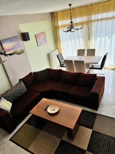 a living room with a brown couch and a table at Sofias Ferienhaus in Kavala