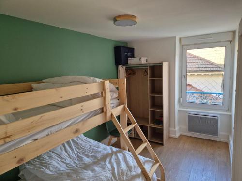 a bedroom with a bunk bed and a window at L’appart Les p’tits Loups in Gérardmer