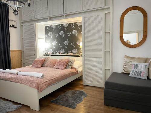 a bedroom with a bed and a mirror at Bíborlak 7 in Villány