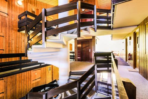 a staircase in a church with wooden walls at Résidence Les Brigues - maeva Home - Appartement 2 pièces 6 personnes Confo 92 in Courchevel