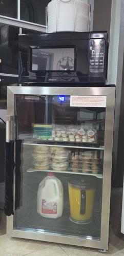 a microwave oven with food inside of a refrigerator at Value Lodge in Alpine