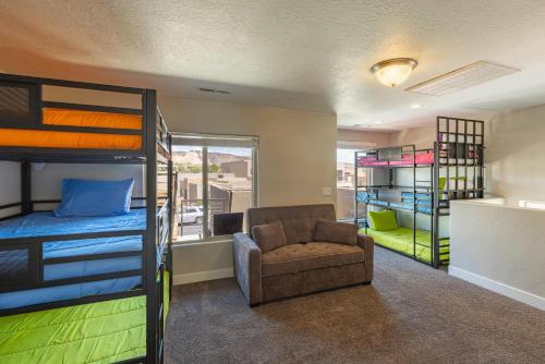 a room with bunk beds and a chair and a couch at Sunny 3-Bedroom Villa in St. George