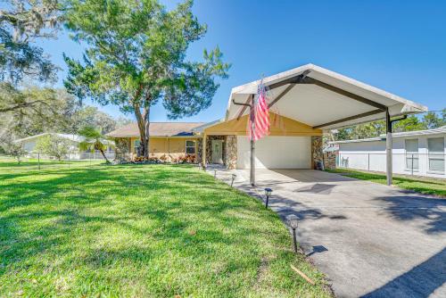 a house with a flag in front of a yard at Private Dock Riverfront Homosassa Home! in Homosassa