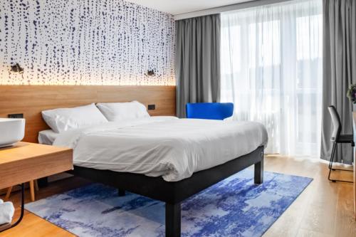 Postel nebo postele na pokoji v ubytování ibis Styles Relax Roznov pod Radhostem