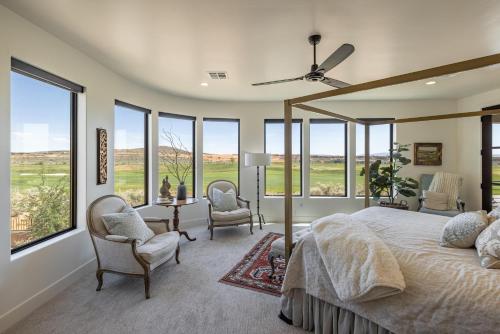 a bedroom with a large bed and windows at Taking Flight in Ivins