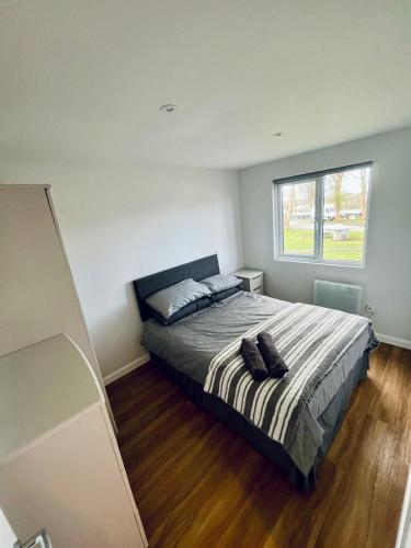 a bedroom with a bed with two pillows on it at Cozy Snowdonia Chalet in Caernarfon