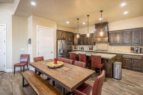 a large kitchen with a wooden table and chairs at 9th Hole Clubhouse Stroll in Ivins