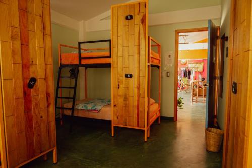 a room with two bunk beds and a doorway at Nopalero Hostel in Puerto Escondido