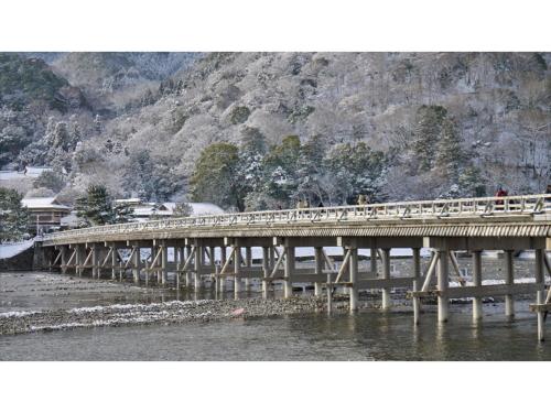 a bridge over a river with people on it at River Side Arashiyama - Vacation STAY 86277v in Kyoto