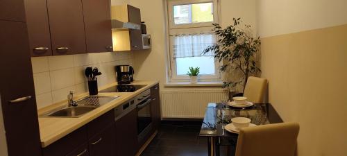 a small kitchen with a sink and a table at Ferienwohnung ASL in Aschersleben