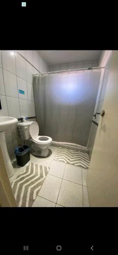 a bathroom with a toilet and a shower curtain at Moko modern studio in Noord