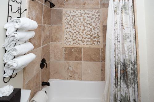 a bathroom with a shower with a shower curtain at Pantai Inn in San Diego