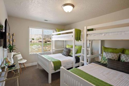 a bedroom with two bunk beds and a window at Desert Haven in St. George