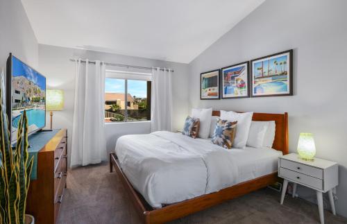a white bedroom with a bed and a window at Convenient & Cozy Downtown - A Ryson Property in Palm Springs