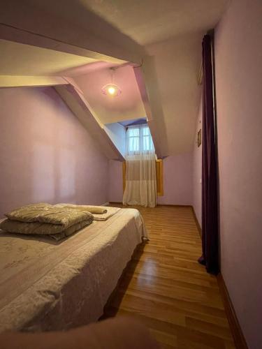 een slaapkamer met een bed en een raam bij two story house in center of the tbilisi in Tbilisi City