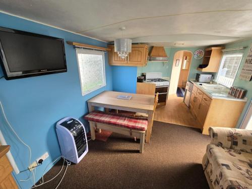 a living room with a table and a kitchen at The daxie 3-Bed caravan in Butlins Skegness in Skegness