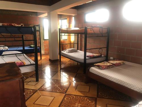 a room with three bunk beds in a room at Finca luminosa in Pereira
