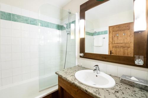 une salle de bain avec un lavabo et un miroir dans l'établissement Résidence Les Arcs 1950 Le Village - maeva Home - Appartement 3 Pièces 6 Personnes - Prestige MAE-2662, à Bourg-Saint-Maurice