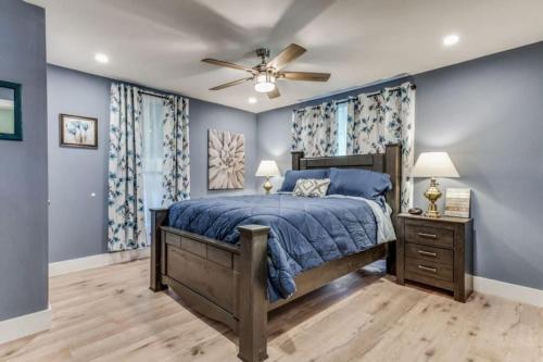 a bedroom with a bed and a ceiling fan at Stockyards! Less than 3 mins-Sleeps 8 -Gable House in Fort Worth