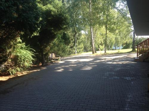 a brick road with trees and a bench on it at Autocamp Skalice in Slapy