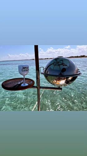 a grill on the back of a boat in the water at Pousada Dona Felicidade Carneiros in Tamandaré