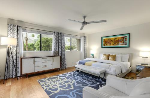 a bedroom with two beds and a blue rug at Eclectic & Comfortable Canyon Corridor - A Ryson Property in Palm Springs