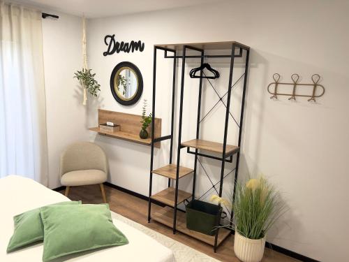 a bedroom with a shelf and a clock on the wall at Große Wohnung & Apartment Sauna & 4 Badezimmer Netflix in Petershagen