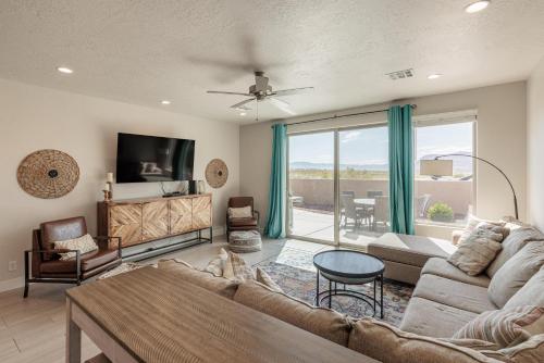 a living room with a couch and a tv at Triple R Getaway in Ivins