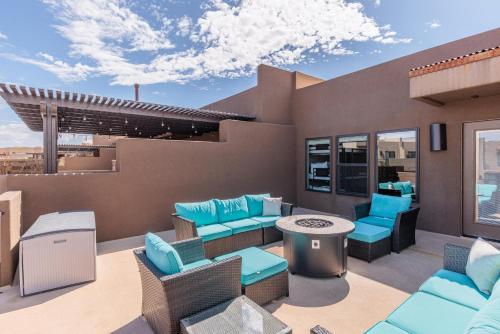 a rooftop patio with blue chairs and a table at Triple R Getaway in Ivins