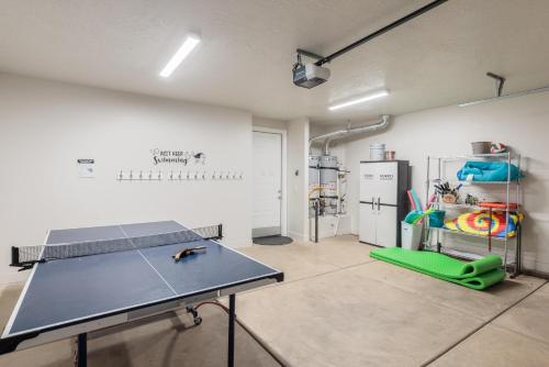 a room with a ping pong table and a refrigerator at Triple R Getaway in Ivins