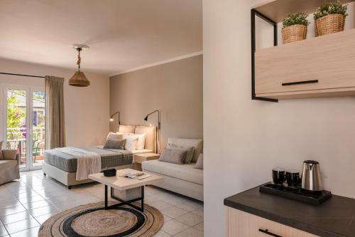 a bedroom and living room with a bed and a table at Rosilion Studios & Apartments in Katelios