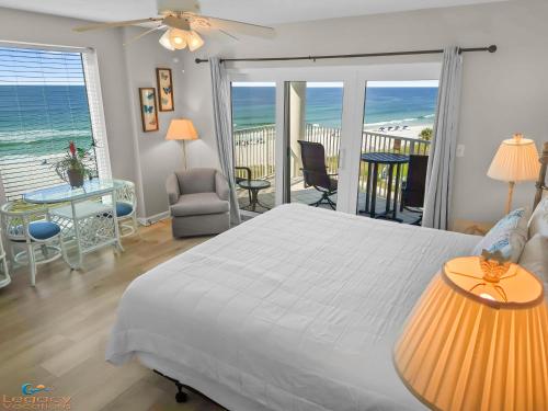 een slaapkamer met een bed en een balkon met uitzicht op de oceaan bij SC 601A - Romantic Beachfront Studio With View! in Fort Walton Beach