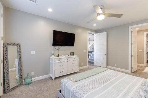 a bedroom with a bed and a tv on the wall at My Happy Place in Ivins