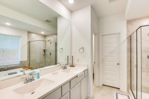 a bathroom with two sinks and a large mirror at Spacious Royse City Home with Community Pool Access in Royse City