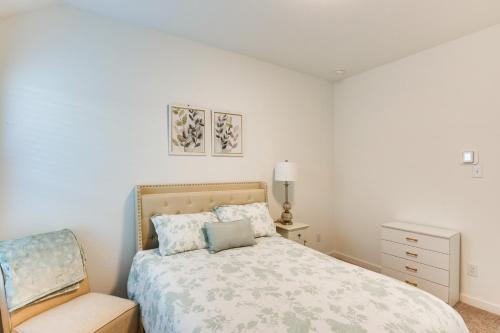 a white bedroom with a bed and a chair at Spacious Royse City Home with Community Pool Access in Royse City
