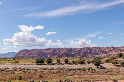 a road in the desert with mountains in the background at Peaceful Easy Feeling in Ivins