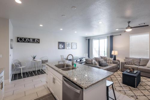a kitchen and living room with a couch and a table at Peaceful Easy Feeling in Ivins