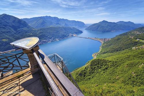 a view of a large body of water with mountains at Lugano Gem Mini Suite Moderna in Lugano