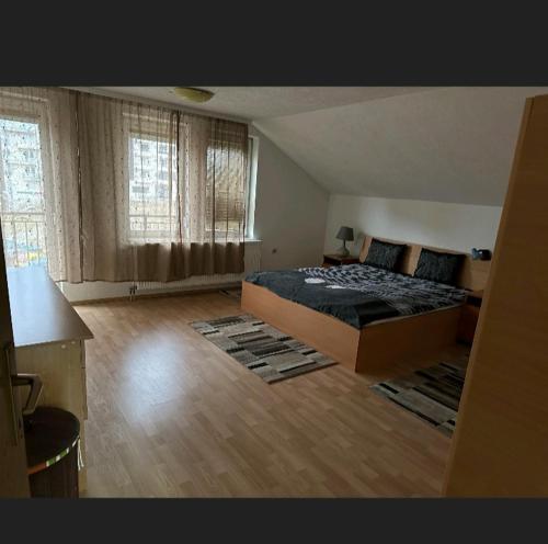 a bedroom with a large bed in a room at A&F apartment in Pristina