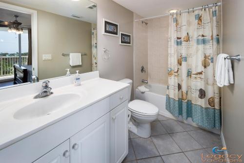 a bathroom with a sink and a toilet and a shower at Destin West Pelican#408-Resort Corner Lazy River! in Fort Walton Beach