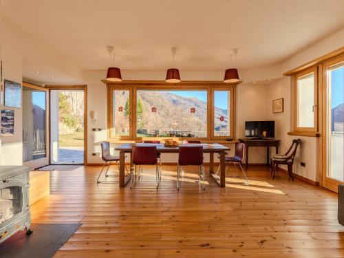 a kitchen and dining room with a table and chairs at Holiday Home Vitali by Interhome in Taceno