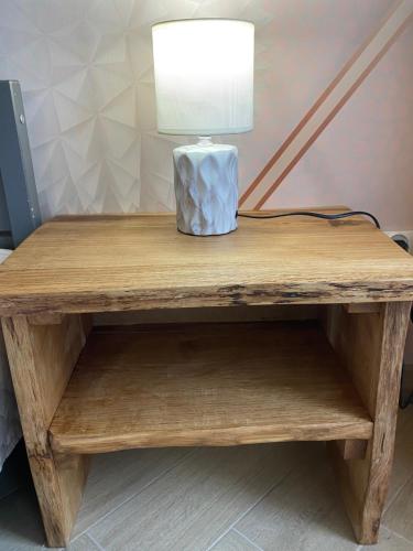 a wooden table with a lamp on top of it at Pokoje u Daniela in Miedzygorze
