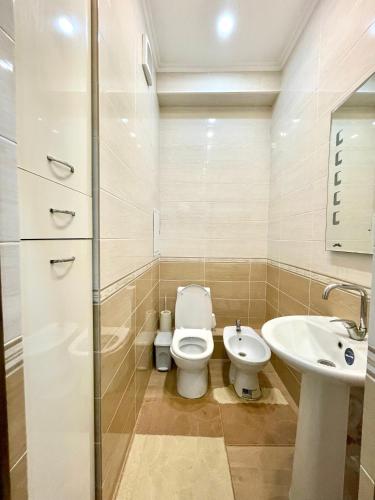 a bathroom with a toilet and a sink at Жилой комплекс Green Park in Aktau
