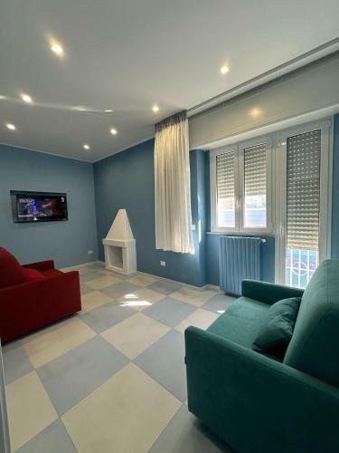 a living room with two couches and a tv at Tra mare e castello in Barletta