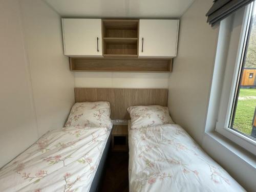 two beds in a small room with a window at Holiday Home Tiny Haus Flussblick by Interhome in Riedenburg