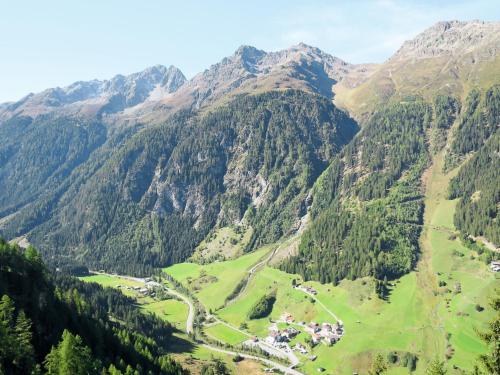 a valley in the mountains with a village at Apartment Dreizimmer- by Interhome in Feichten