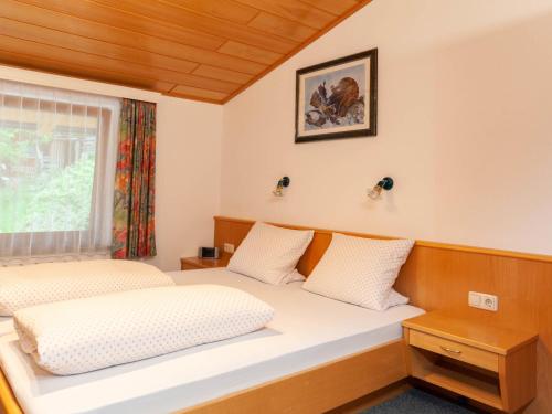 a bedroom with two beds and a window at Apartment Aurora Apartment Top I by Interhome in Kappl