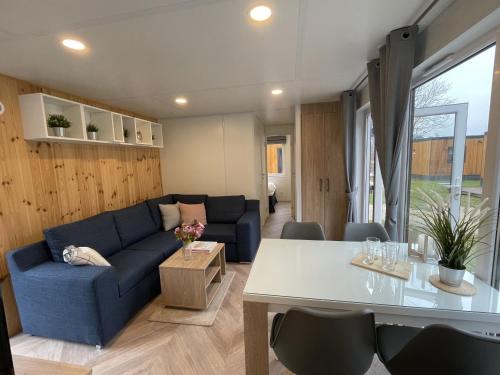 a living room with a blue couch and a table at Holiday Home Tiny Haus Elena by Interhome in Riedenburg